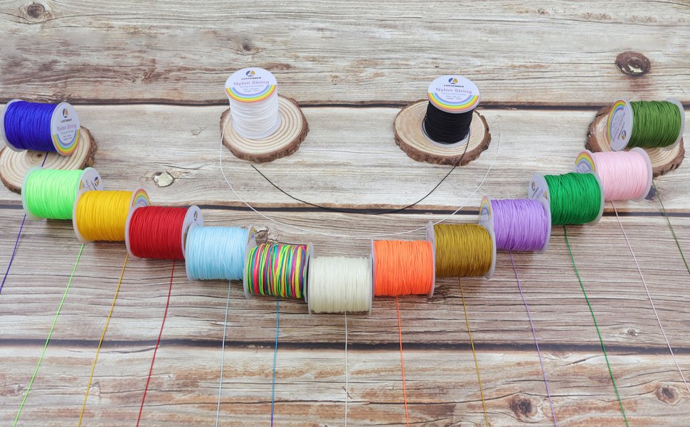 Assortment of colorful nylon string spools arranged on a wooden background, with individual strings fanned out.