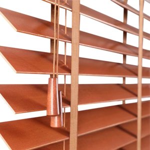 Close-up of wooden blinds with pull cords and tassels, angled view against a white background.