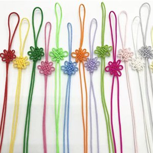 Assortment of colorful nylon cords with decorative knots, arranged vertically.