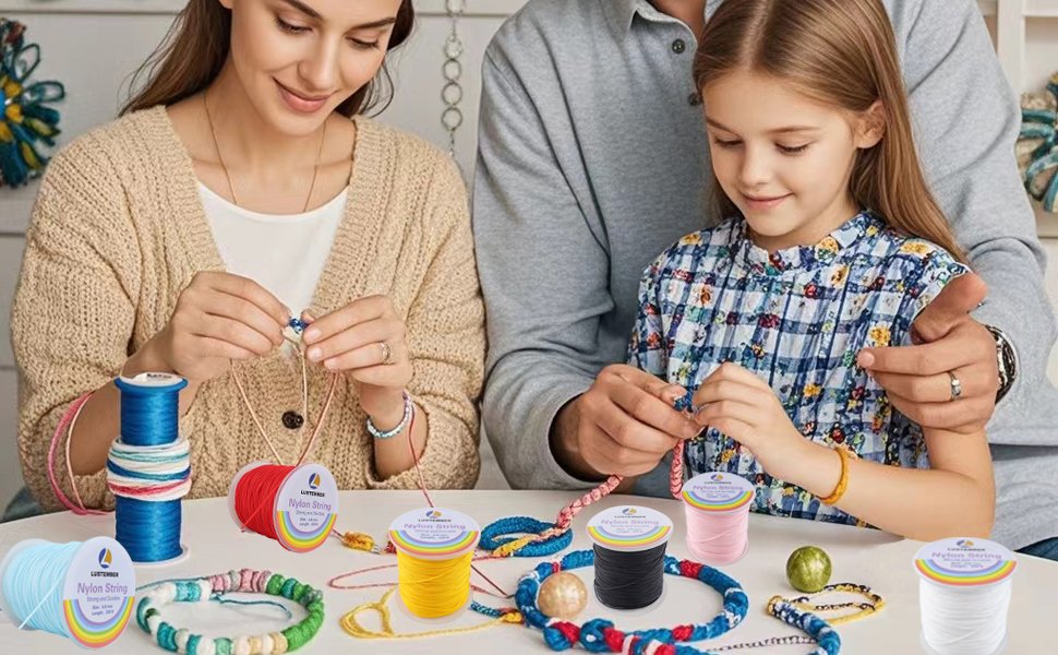 Family making jewelry with colorful nylon string spools on a table
