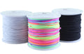 Three spools of elastic beading cord: one white, one multi-colored, and one black, shown from the front.