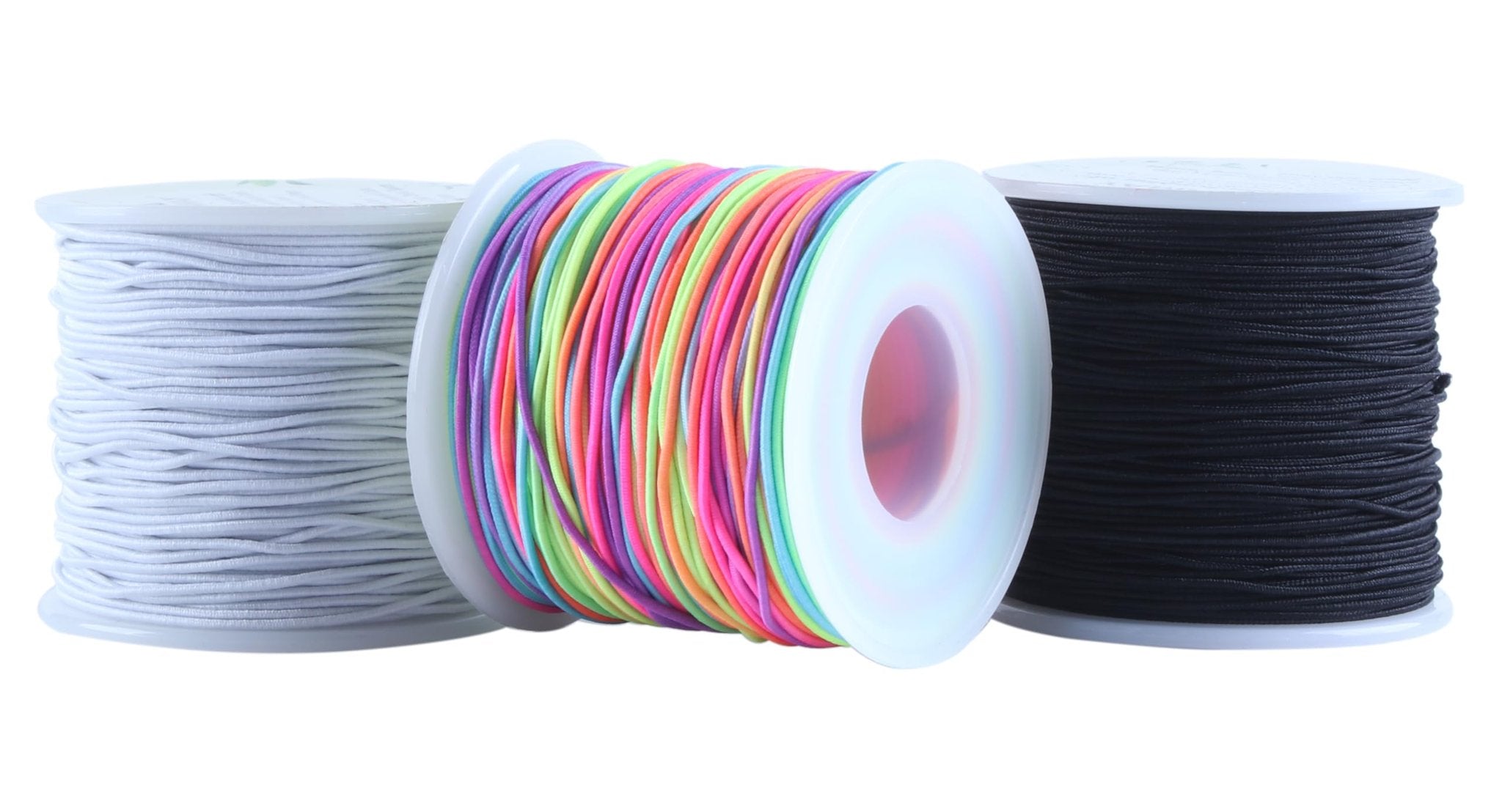 Three spools of elastic beading cord: white, multi-color, and black, on a white background.