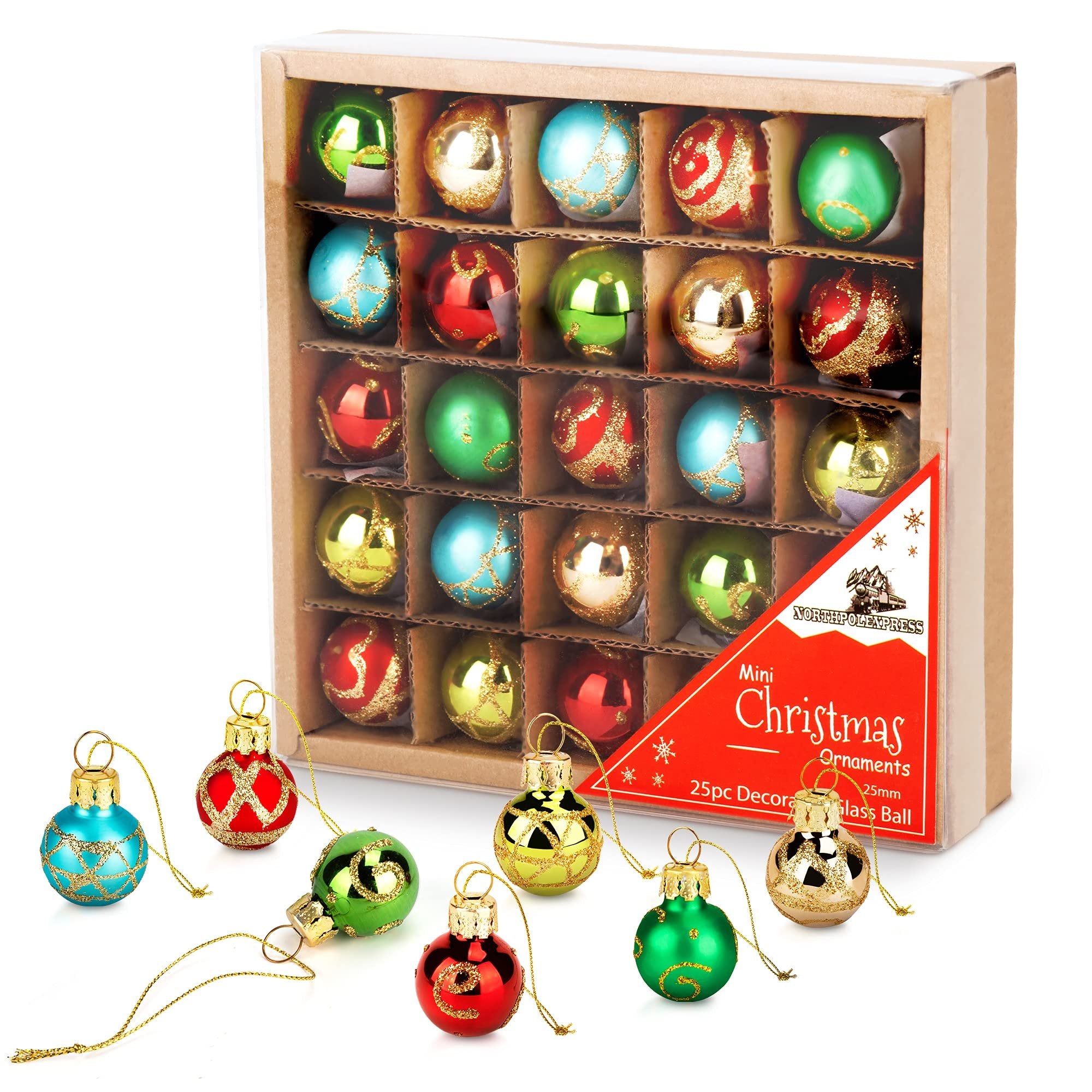 Set of 25 mini glass Christmas ornaments in red, blue, and gold, some displayed in a cardboard box and others scattered in front.