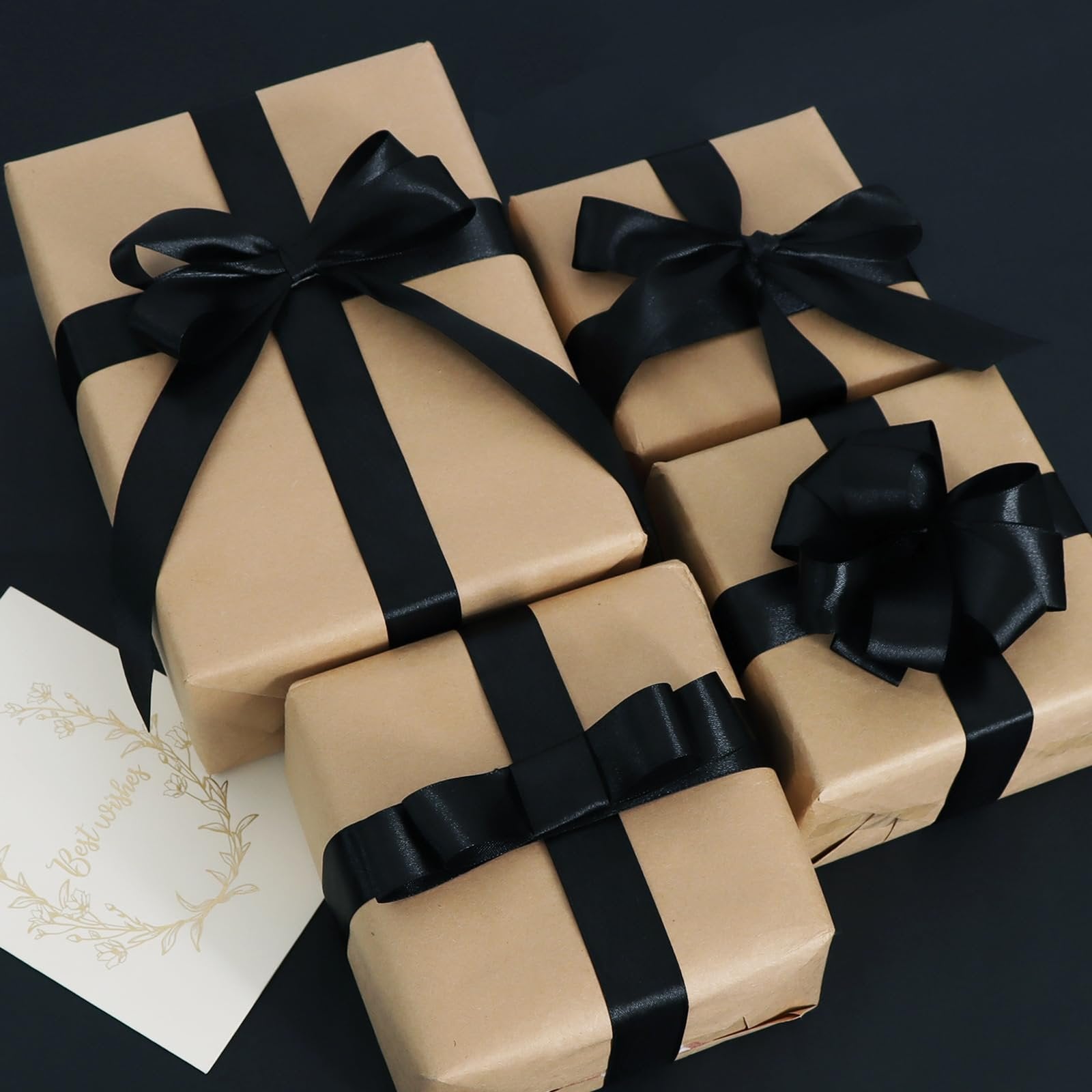 Several gift-wrapped packages with black satin ribbon and a 'Best wishes' card.