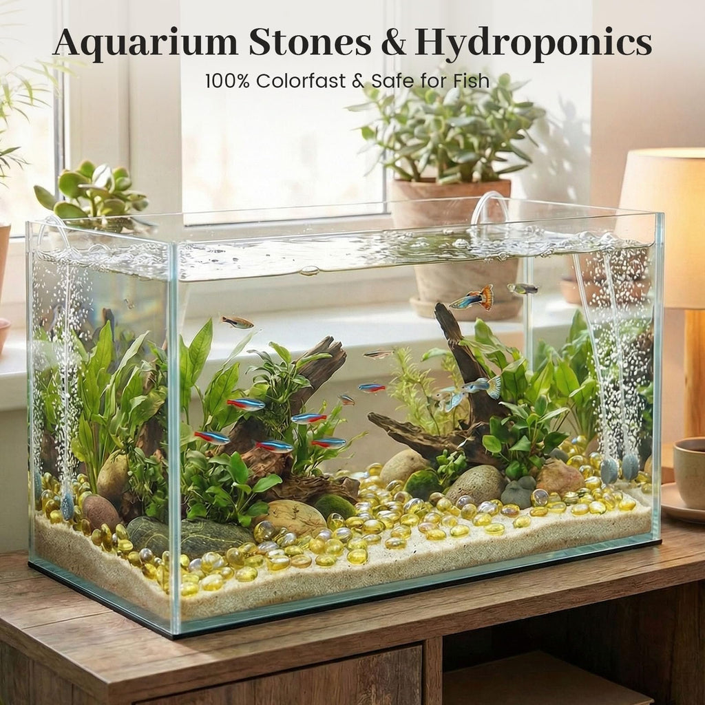 Aquarium filled with amber glass marbles, plants, and fish, set on a wooden stand.