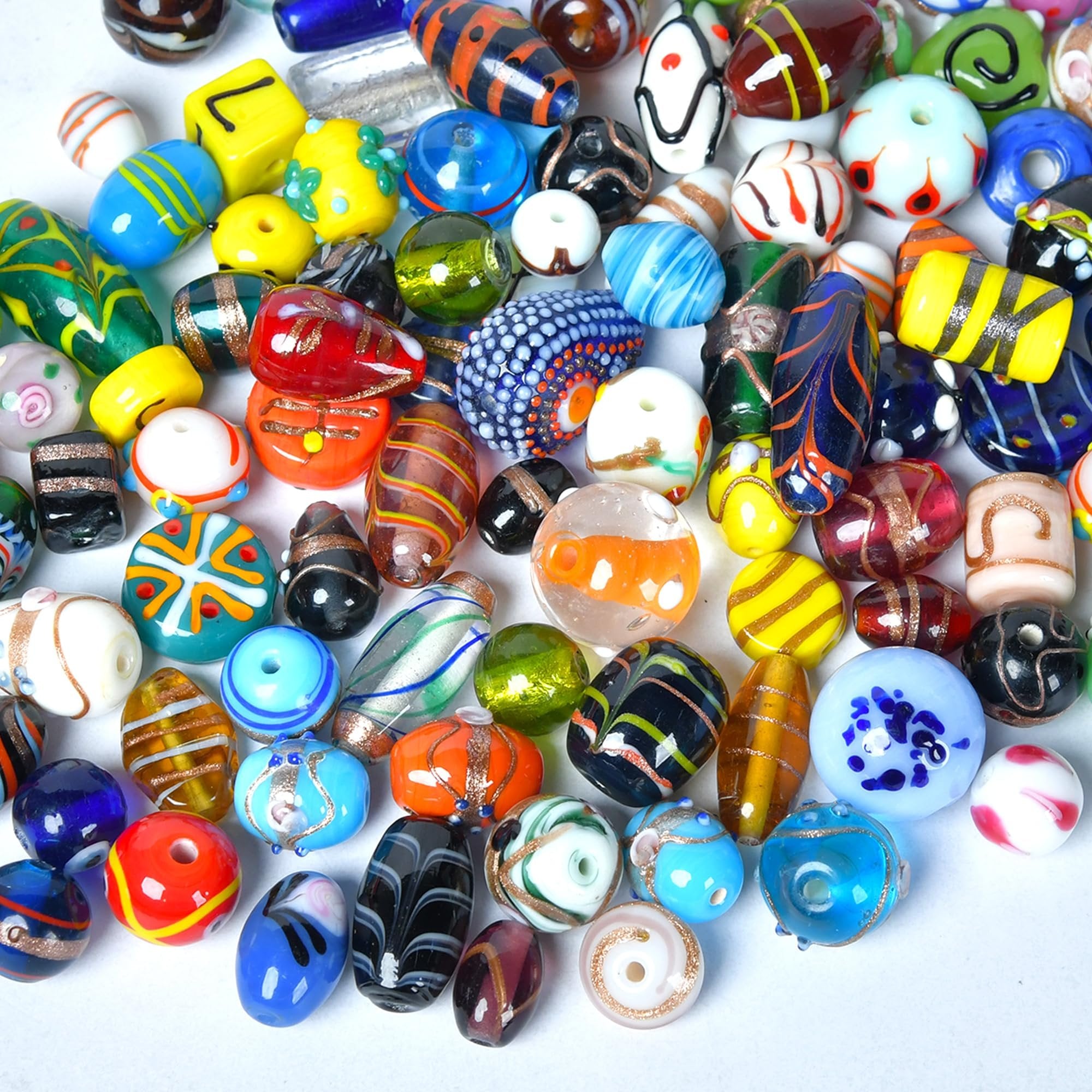 Assorted glass beads with various colors and patterns, including lampwork Murano-style handmade beads for jewelry making.