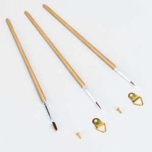 Paint by numbers kit accessories including three brushes, two D-ring hangers, and two screws on a white background.