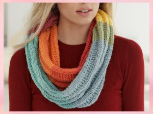 Woman wearing a multicolored knit infinity scarf made from sparkle yarn