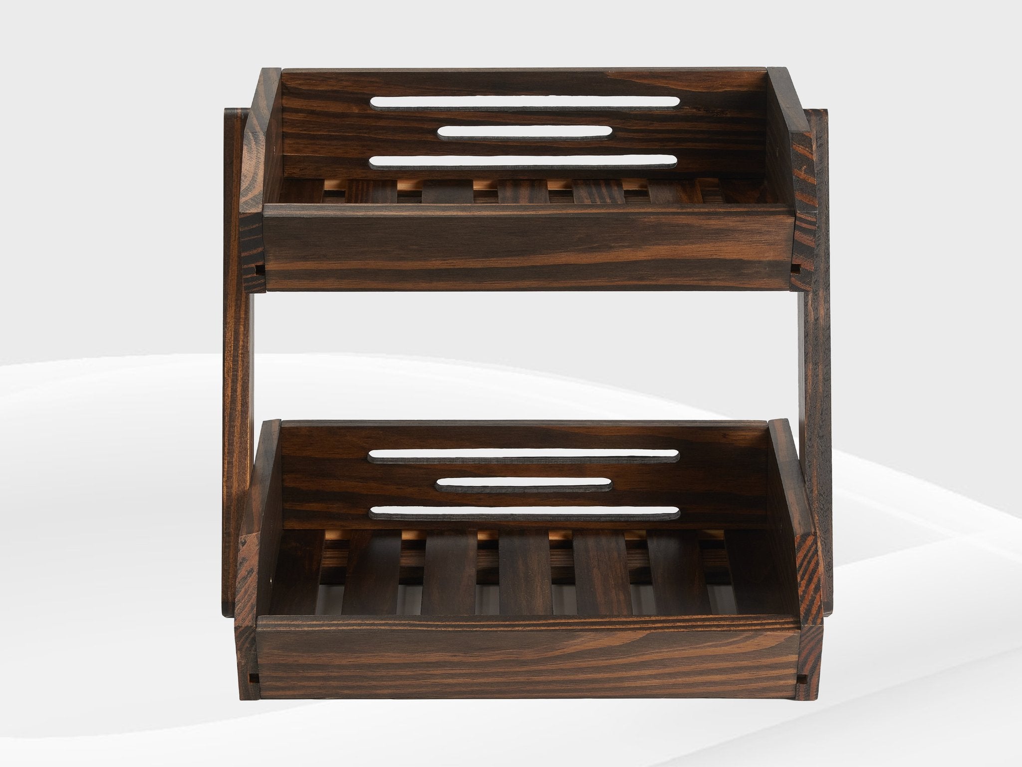 Two-tier dark wood fruit basket with slatted shelves and side supports, shown from the front.