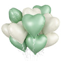 Bunch of sage green and beige heart-shaped foil balloons with white curling ribbons against a white background.
