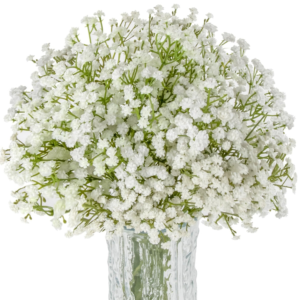 Bouquet of white artificial baby's breath flowers in a textured glass vase against a white background.