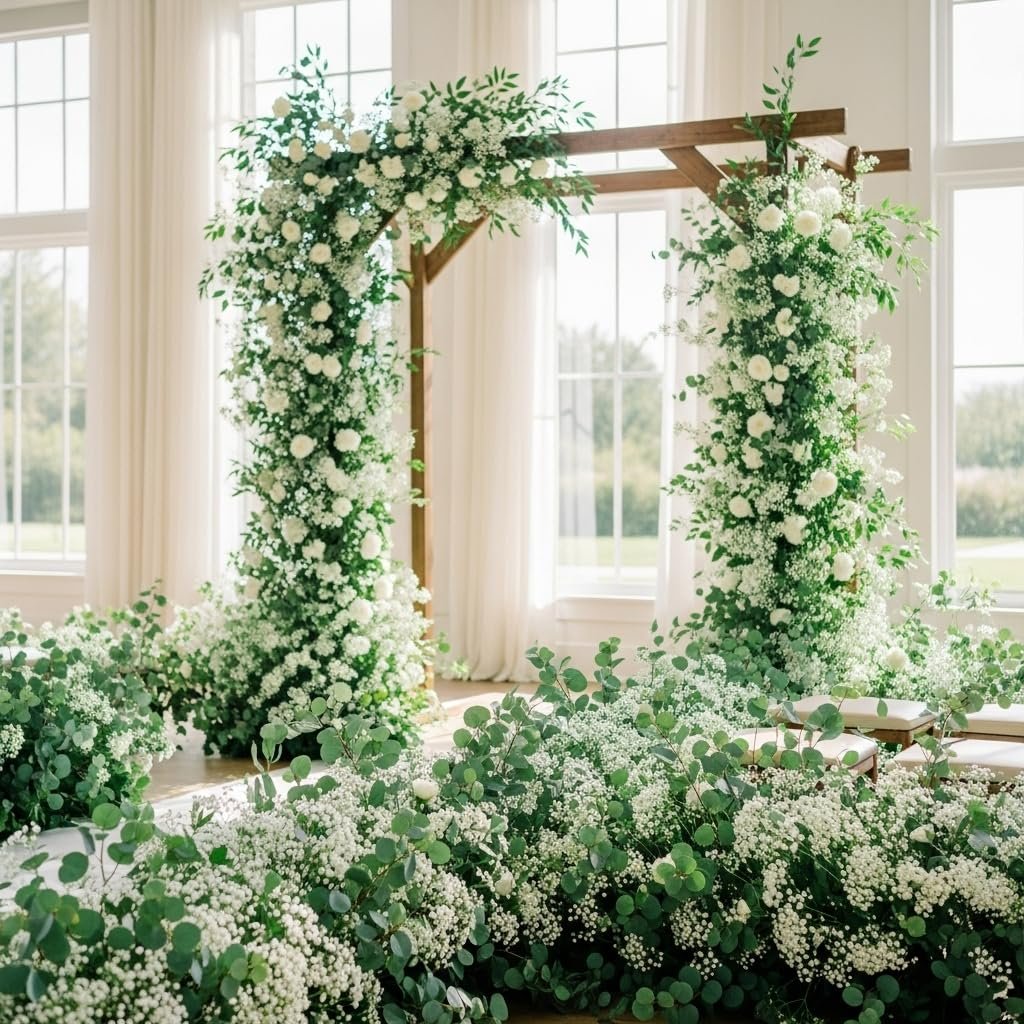 Wedding arch decorated with white roses and baby's breath flowers, with floral arrangements on the floor.