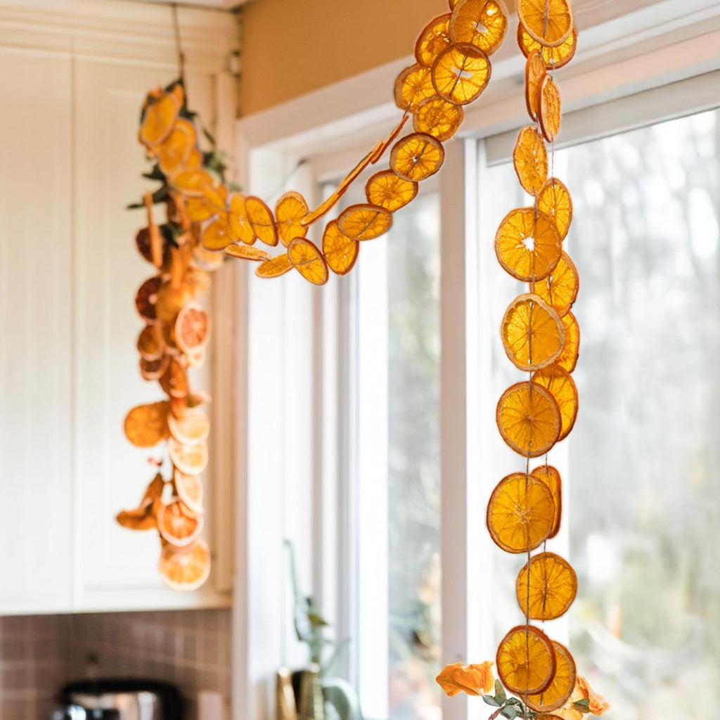 Dried orange slice garland with jute twine hanging in front of a window