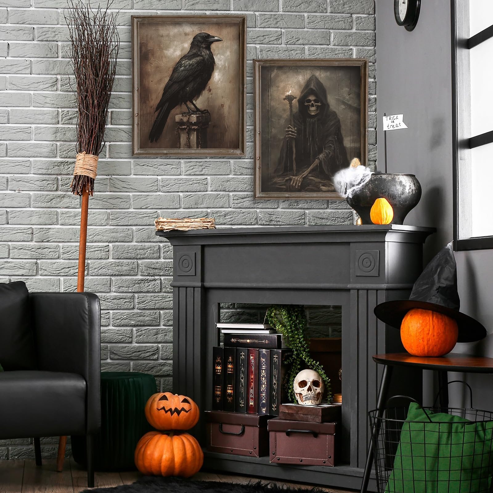 Halloween decor scene with two framed dark art prints, a broom, pumpkins, skull, and cauldron.