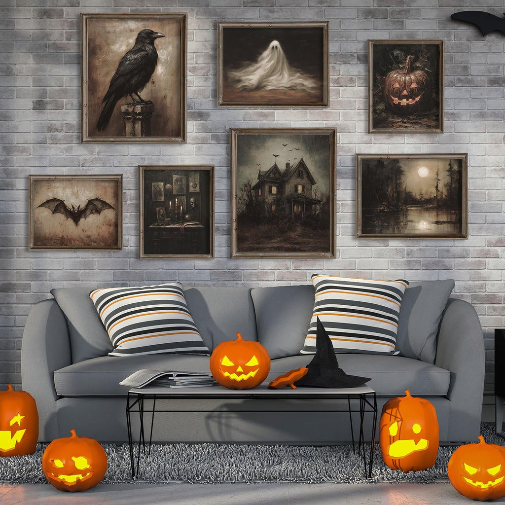 Living room scene with Halloween decor, featuring framed dark art prints of a crow, ghost, pumpkin, bat, haunted house, and moonlit landscape above a gray sofa with striped pillows and pumpkins.