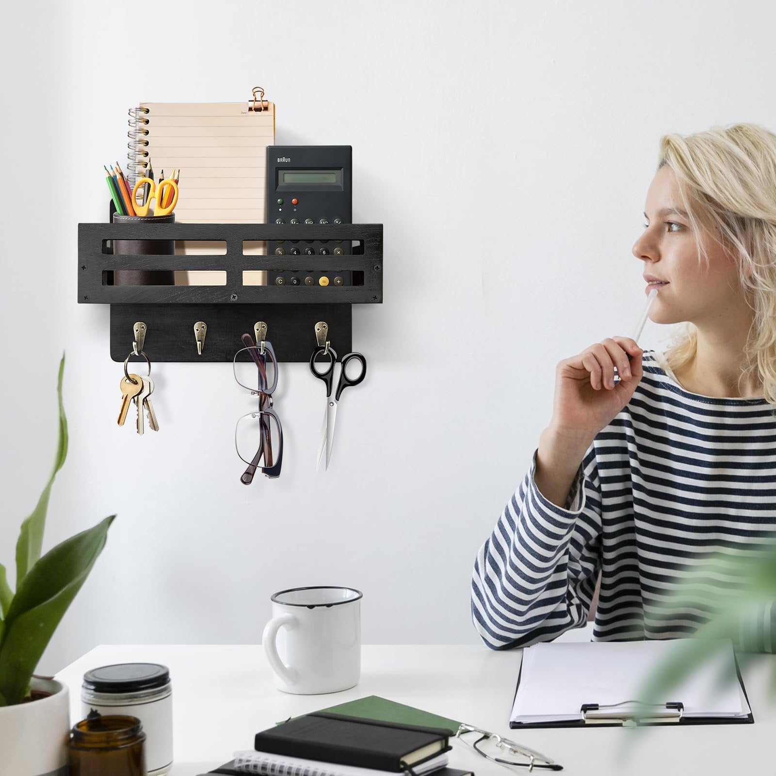 Black wooden key and mail holder with 4 hooks, organizer shelf, keys, glasses, and scissors hanging on a white wall.