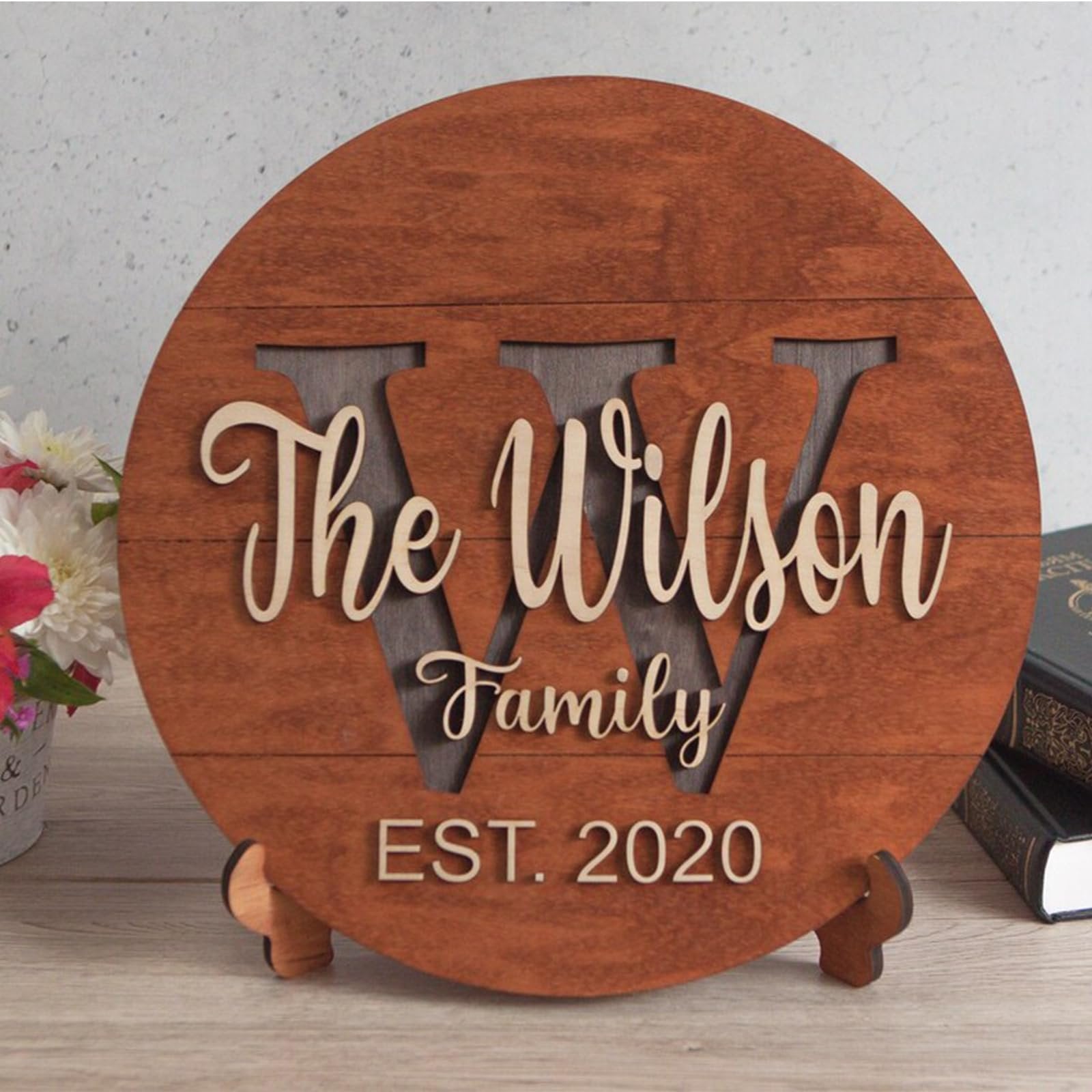 Wooden family name sign with cutout 'W' and text 'The Wilson Family EST. 2020' on a stand.