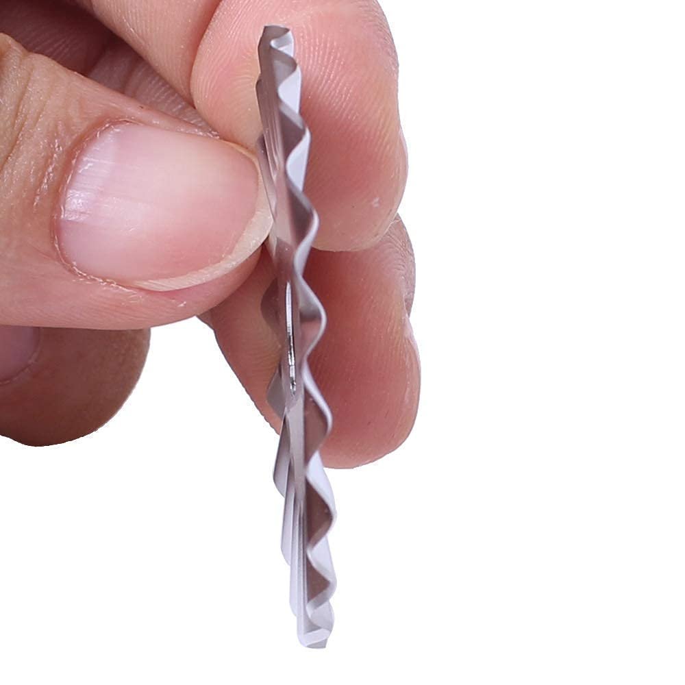 Close-up side view of a pinking rotary cutter replacement blade held by fingers against a white background.
