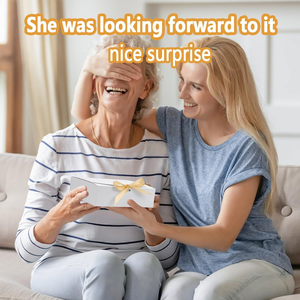 Woman giving a white gift box with a yellow ribbon to an older woman covering her eyes