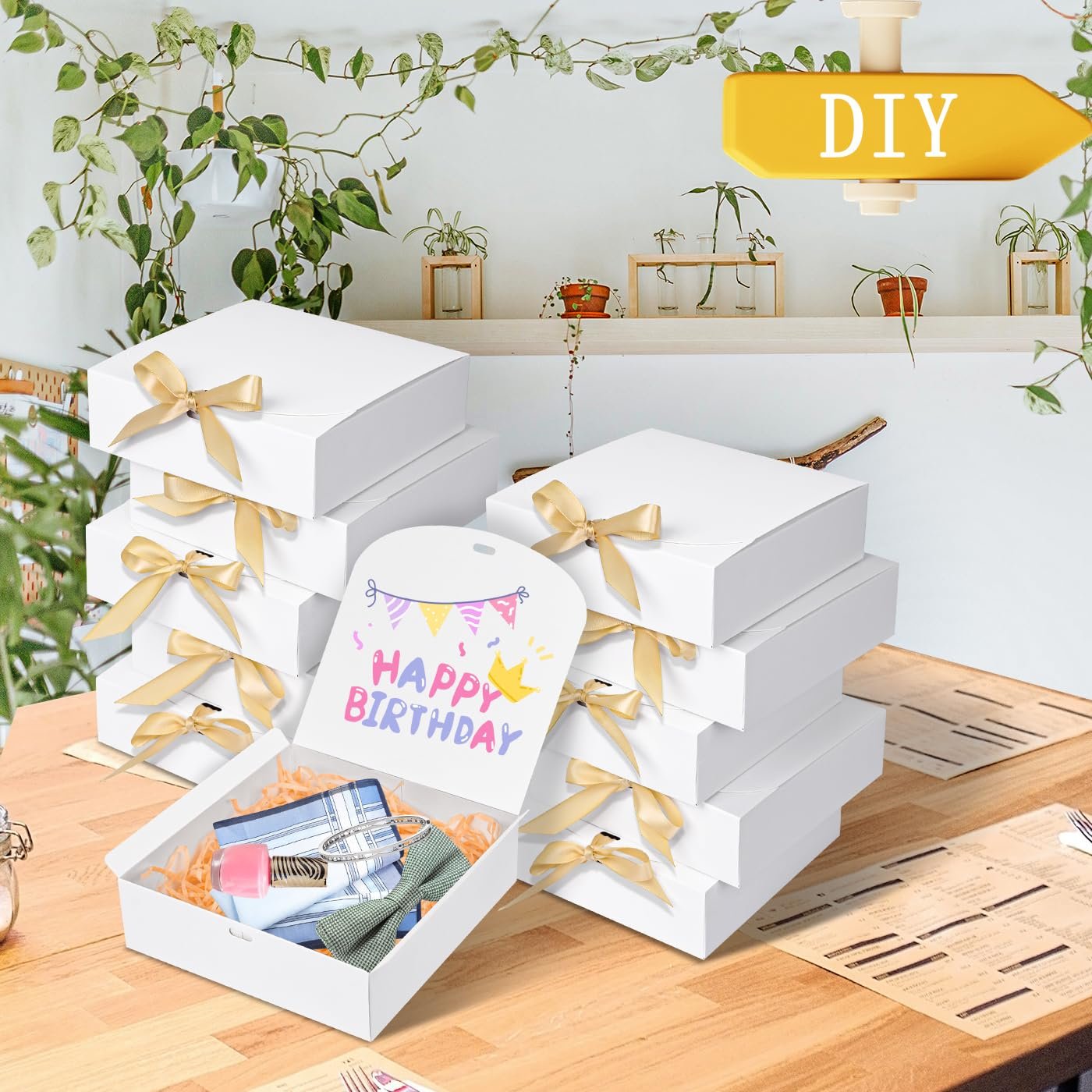 Ten white paper gift boxes with gold ribbon, one open showing contents and a happy birthday tag.