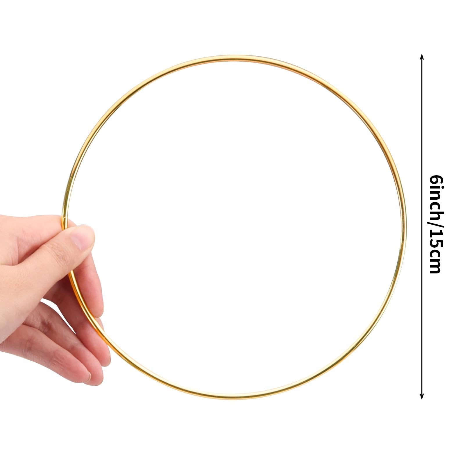 Hand holding a gold metal ring, with a size indicator showing 6inch/15cm