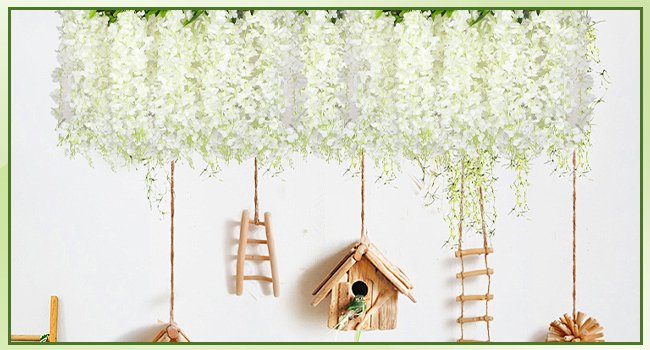 White artificial wisteria garlands hanging with decorative ladders and birdhouse