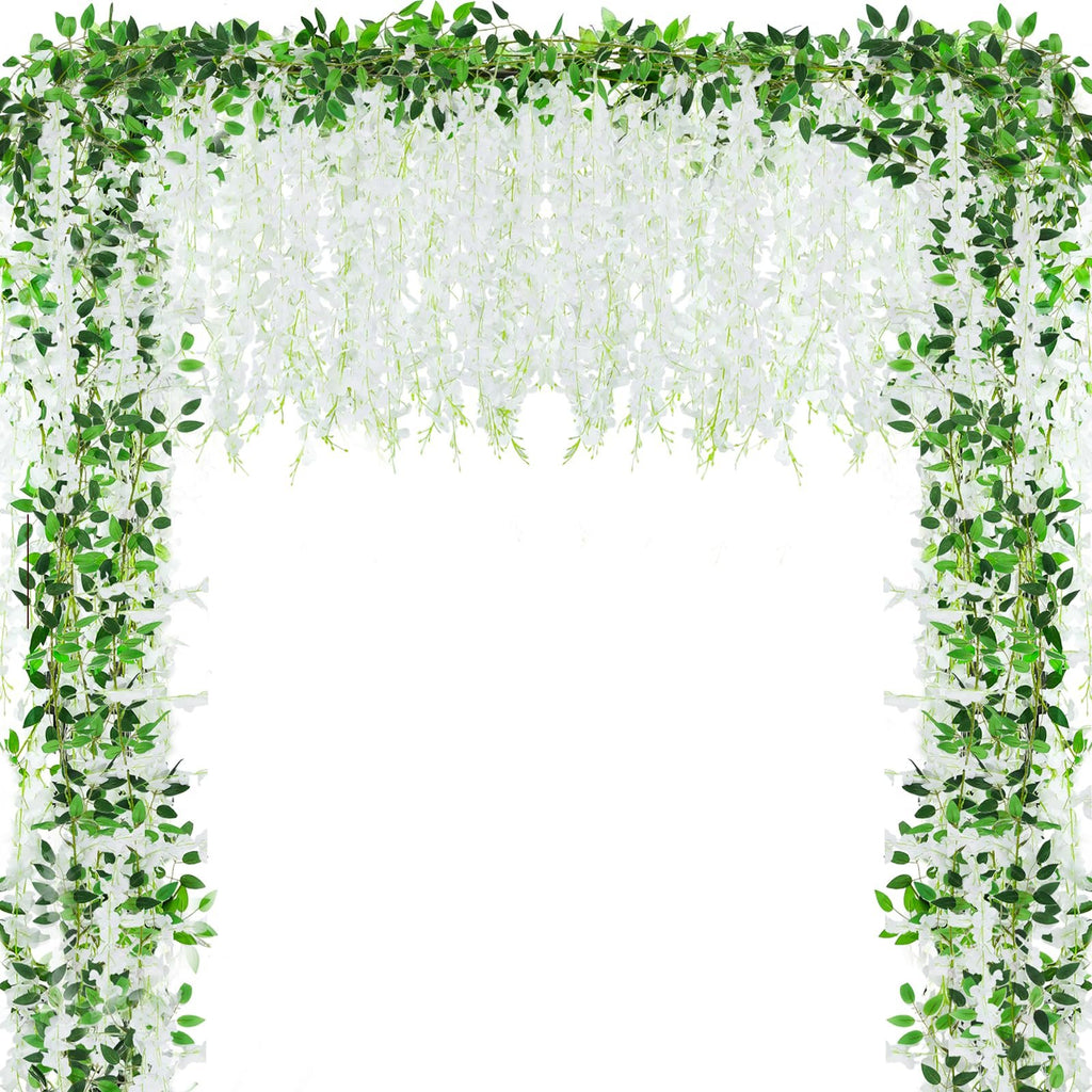 White artificial wisteria garland with green leaves draped in an arch shape against a white background.
