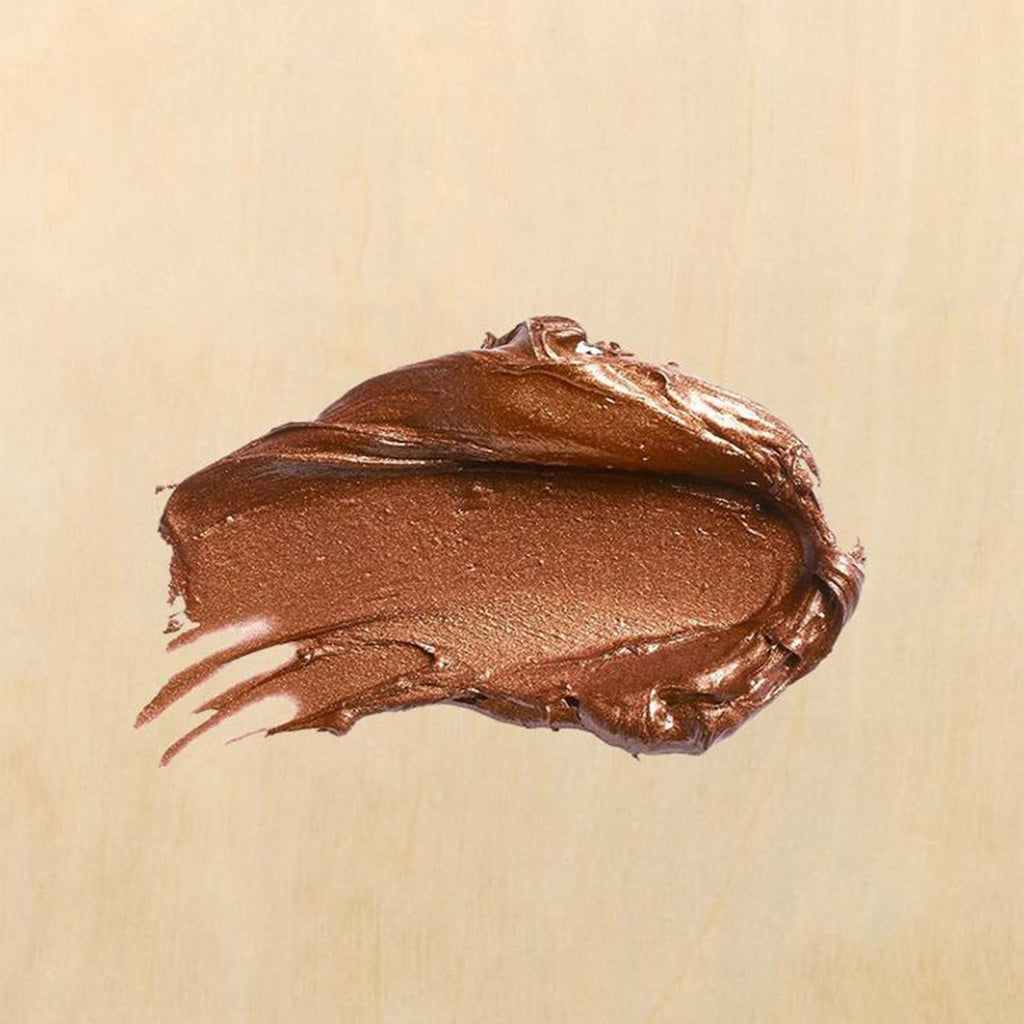 Bronze metallic paint swatch on a light wood grain background