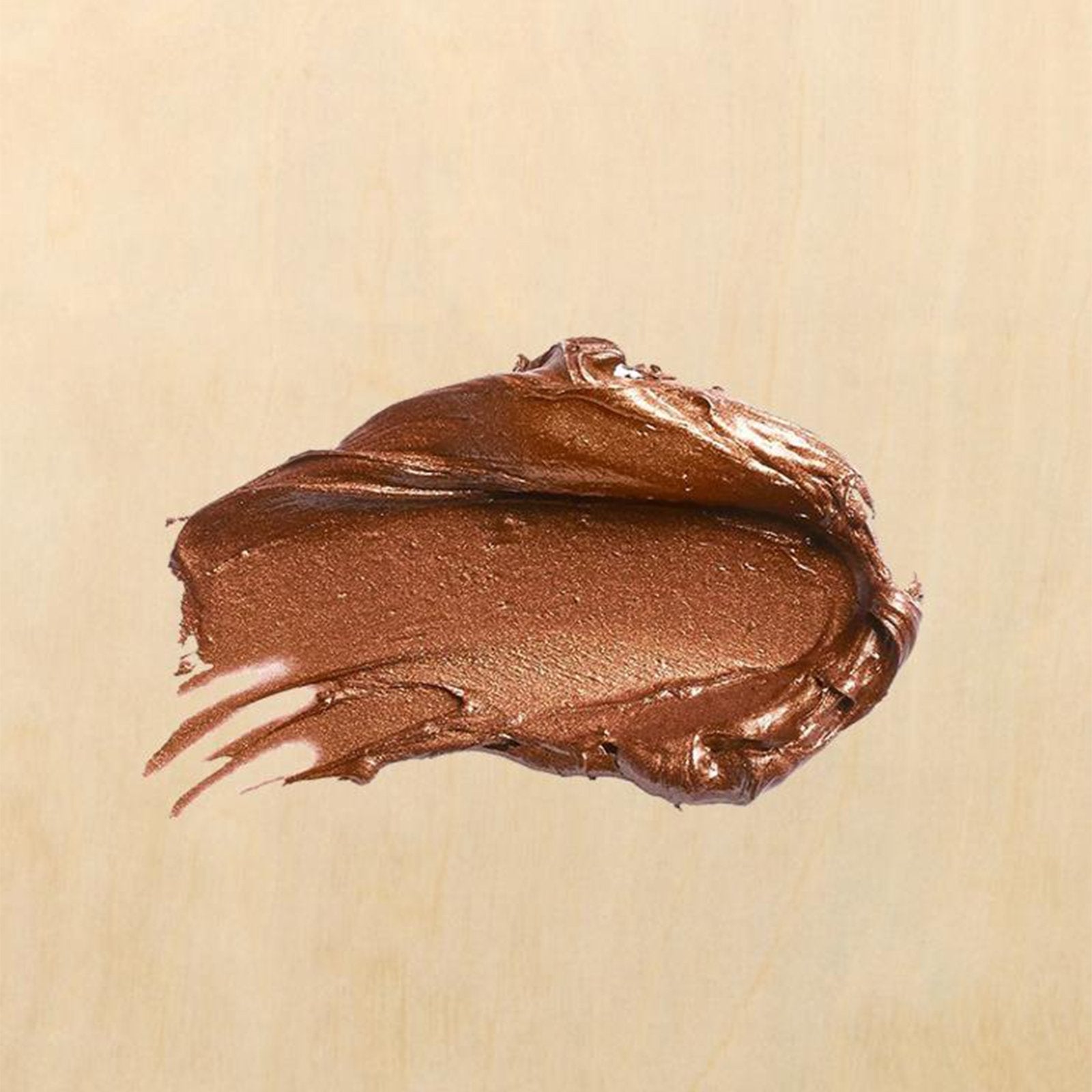 Bronze metallic paint swatch on a light wood grain background