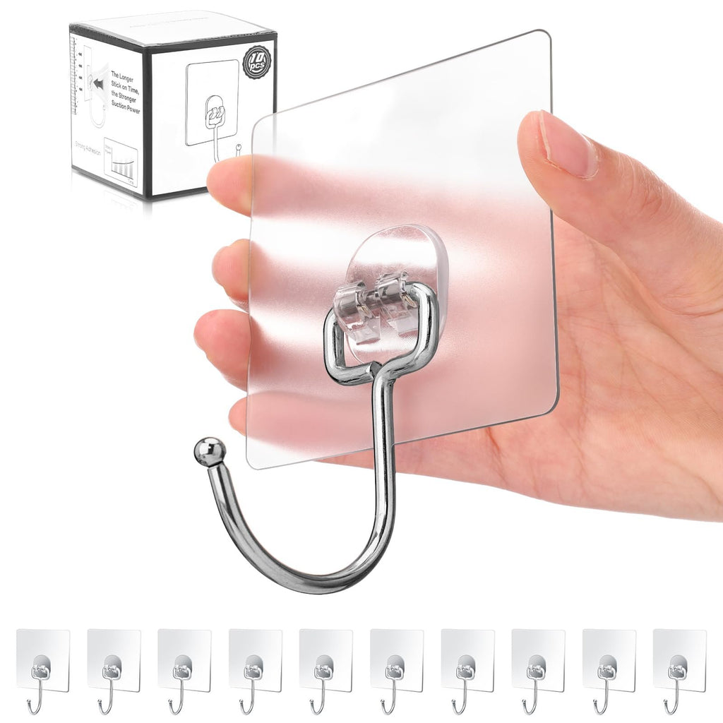 Hand holding a transparent adhesive wall hook with a silver hook, showing the product and packaging.