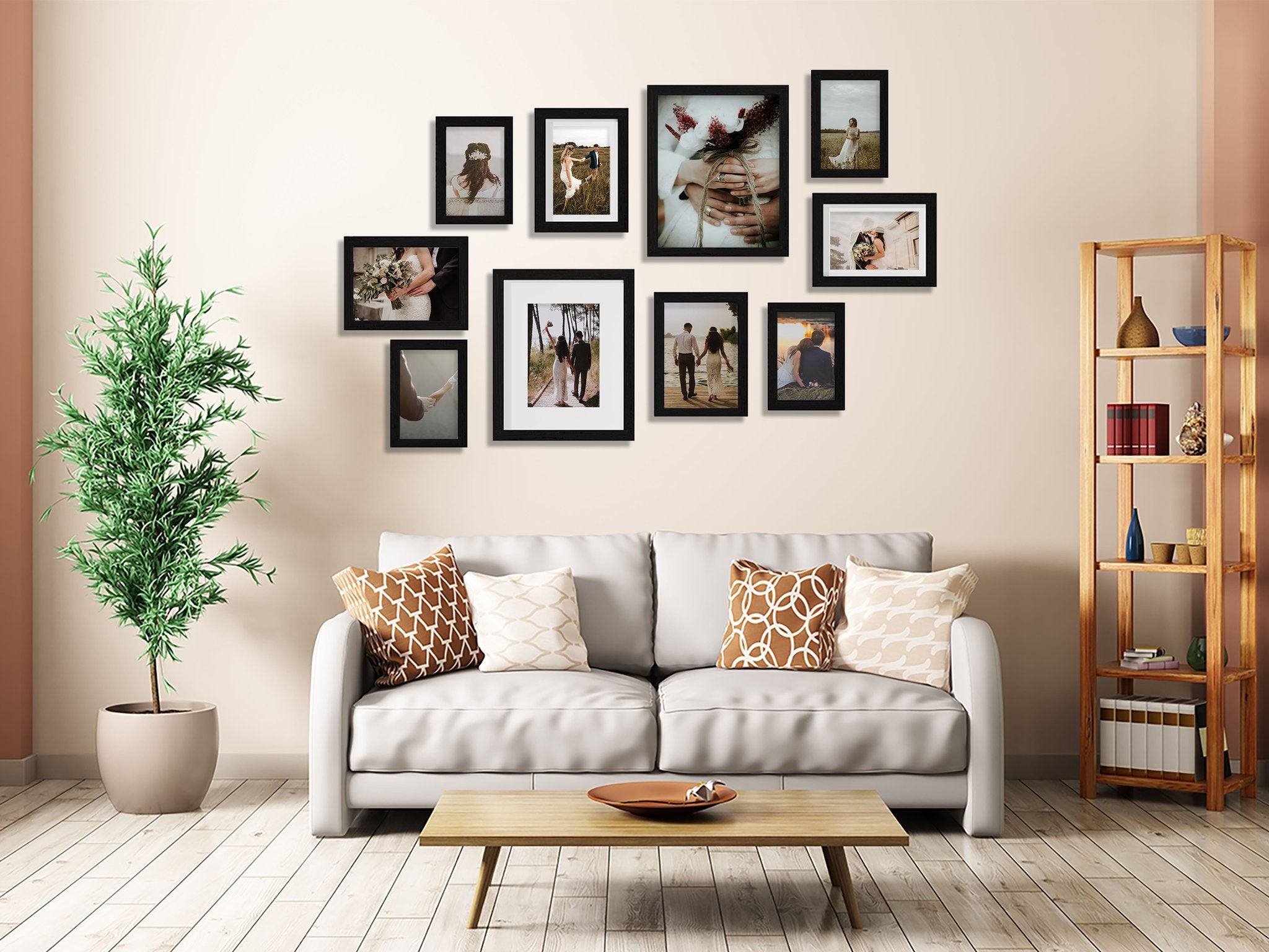 Gallery wall of ten black picture frames arranged above a white sofa with decorative pillows and a wooden coffee table.