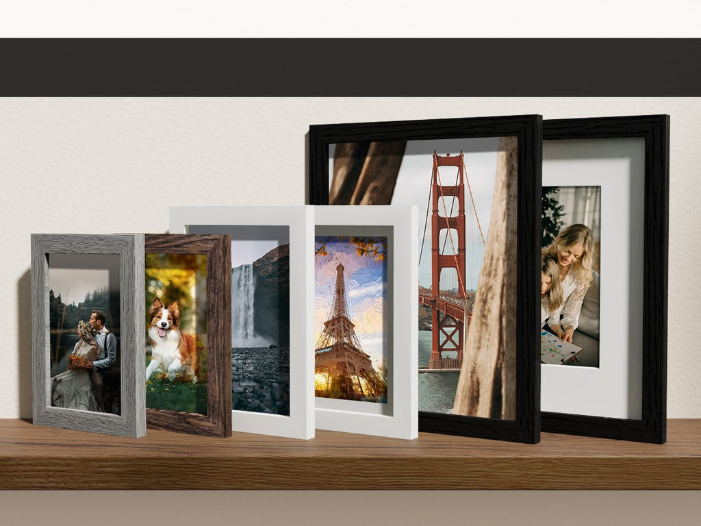 Gallery wall set of picture frames in black, brown, and grey, displaying various scenic photos.