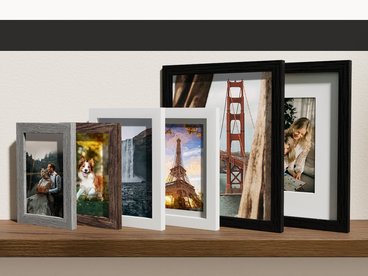 Gallery wall set of picture frames in black, brown, and grey, displaying various scenic photos.