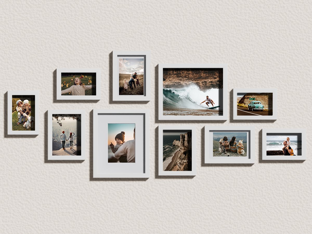 Gallery wall arrangement of ten white picture frames displaying various lifestyle photos on a textured wall.