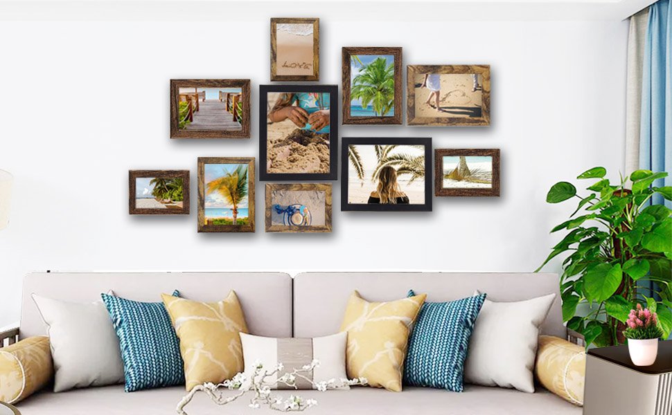 Gallery wall of ten rustic brown picture frames displaying beach and tropical scenes above a sofa.
