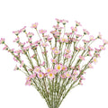 Bouquet of artificial pink forsythia branches with delicate white and yellow centers, set against a white background.