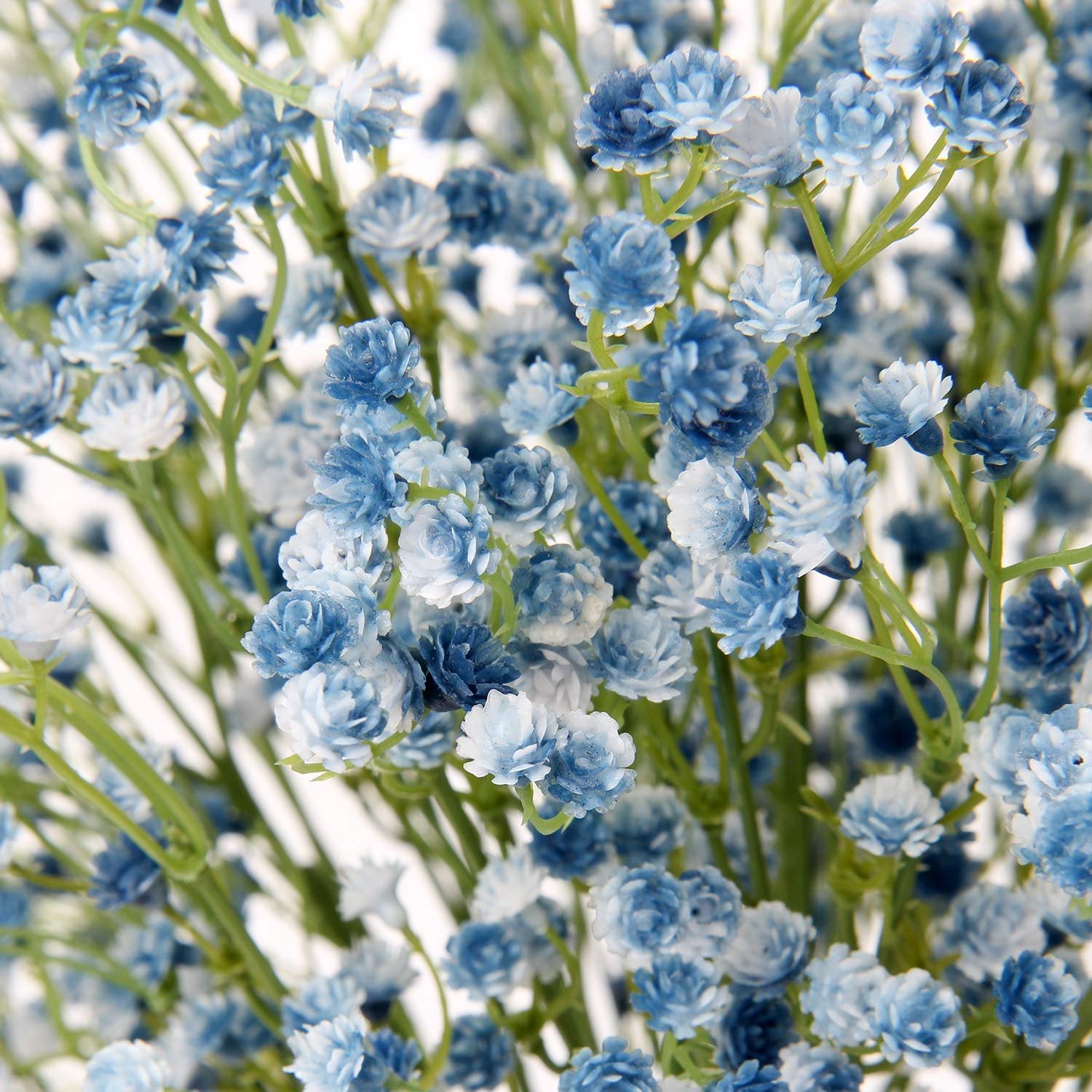 Close-up of blue artificial baby's breath flowers with green stems against a white background.