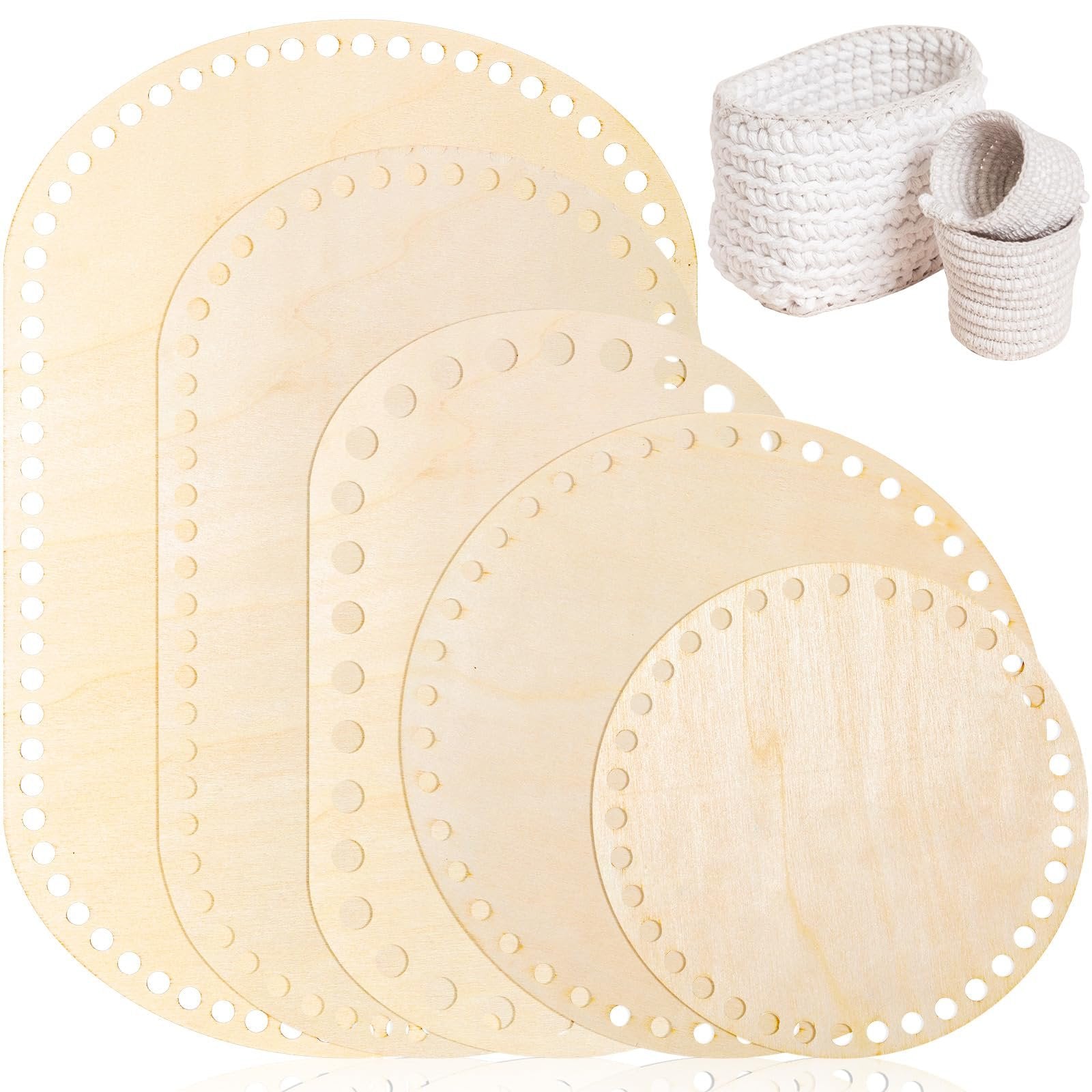 Set of 5 wooden basket bottoms for crochet, including oval and round shapes, with two finished white baskets in background.