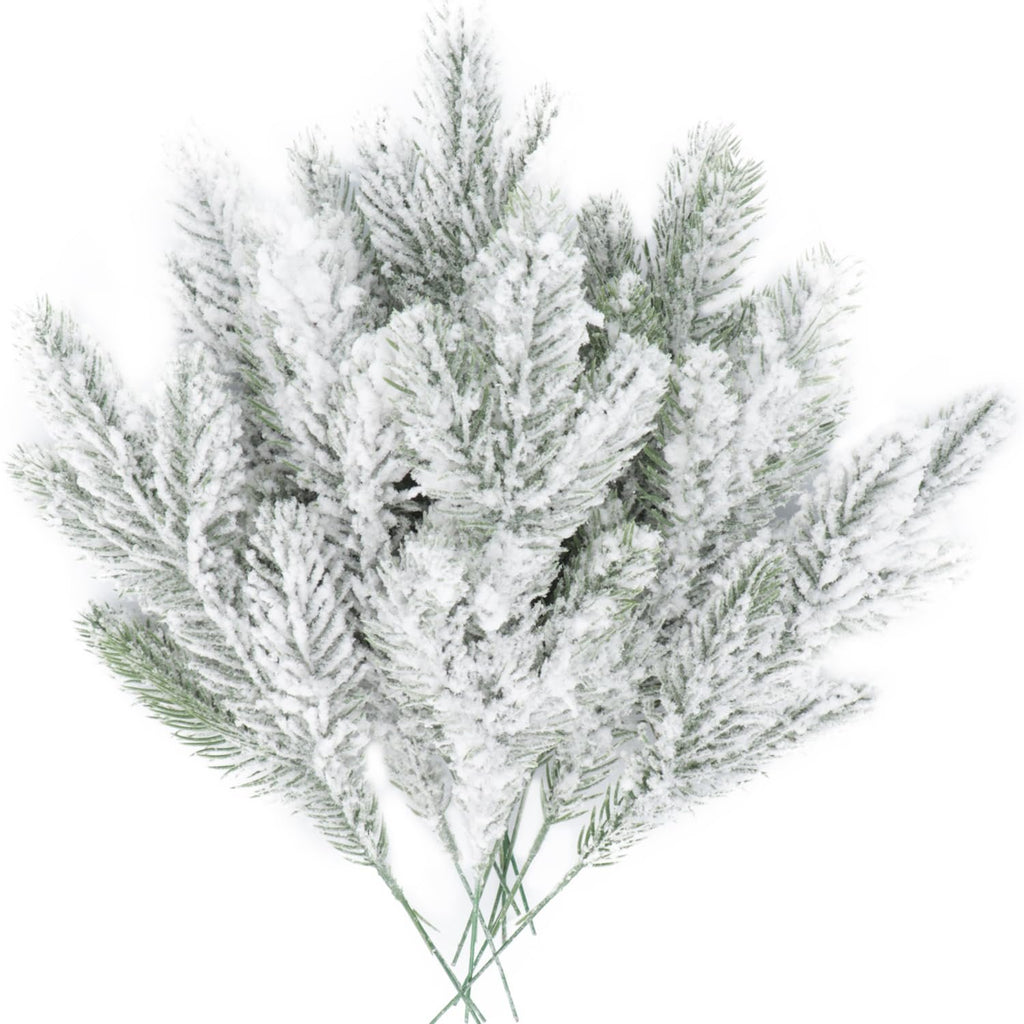 A bunch of frosted artificial pine needle branches with white snow-like covering on a white background.