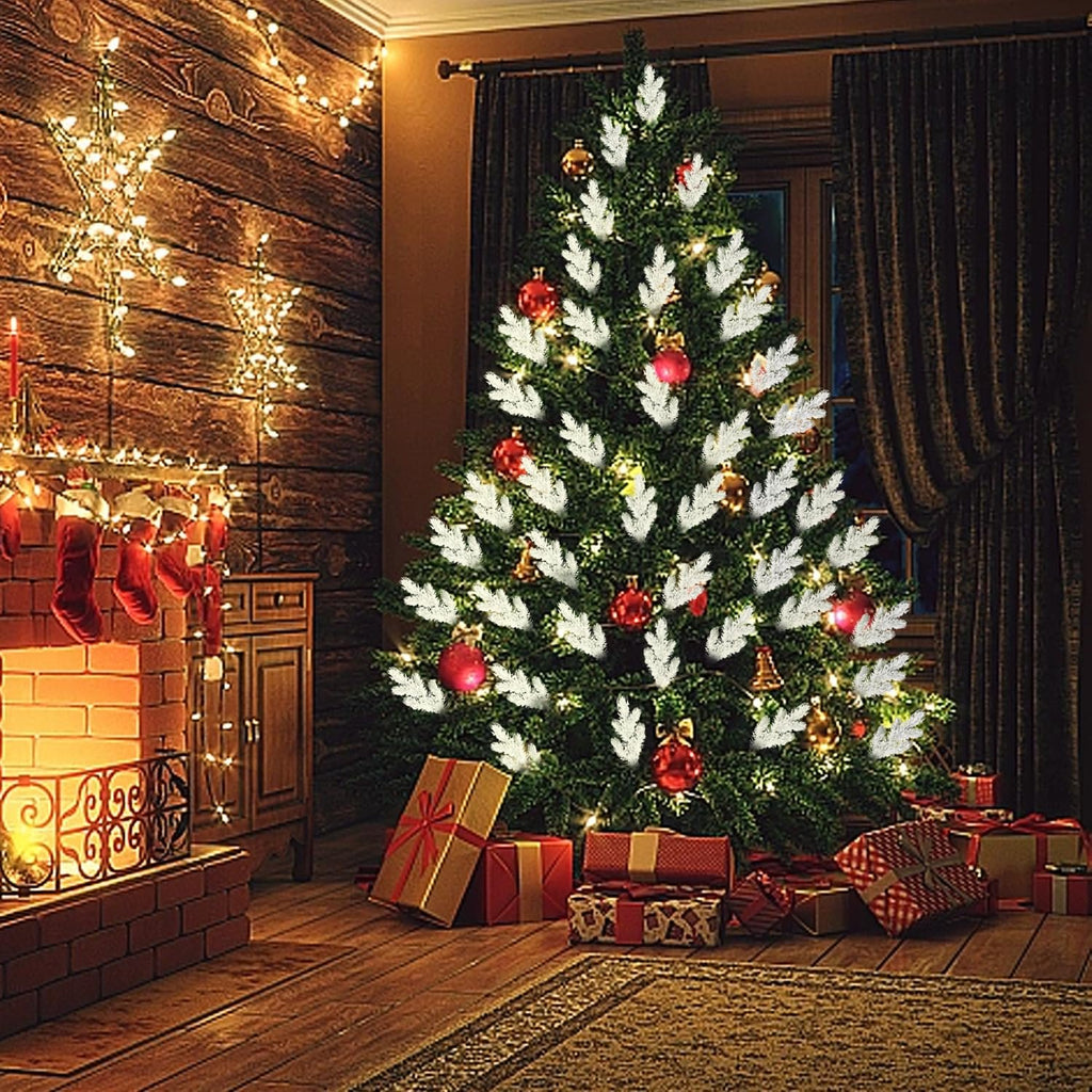 Christmas tree decorated with frosted pine needle branches, ornaments, and lights, near a fireplace with stockings and gifts.