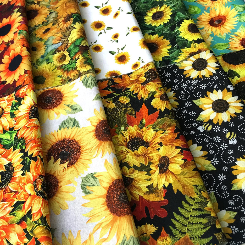 Assortment of sunflower print fabric squares with various backgrounds including white, black, and teal.
