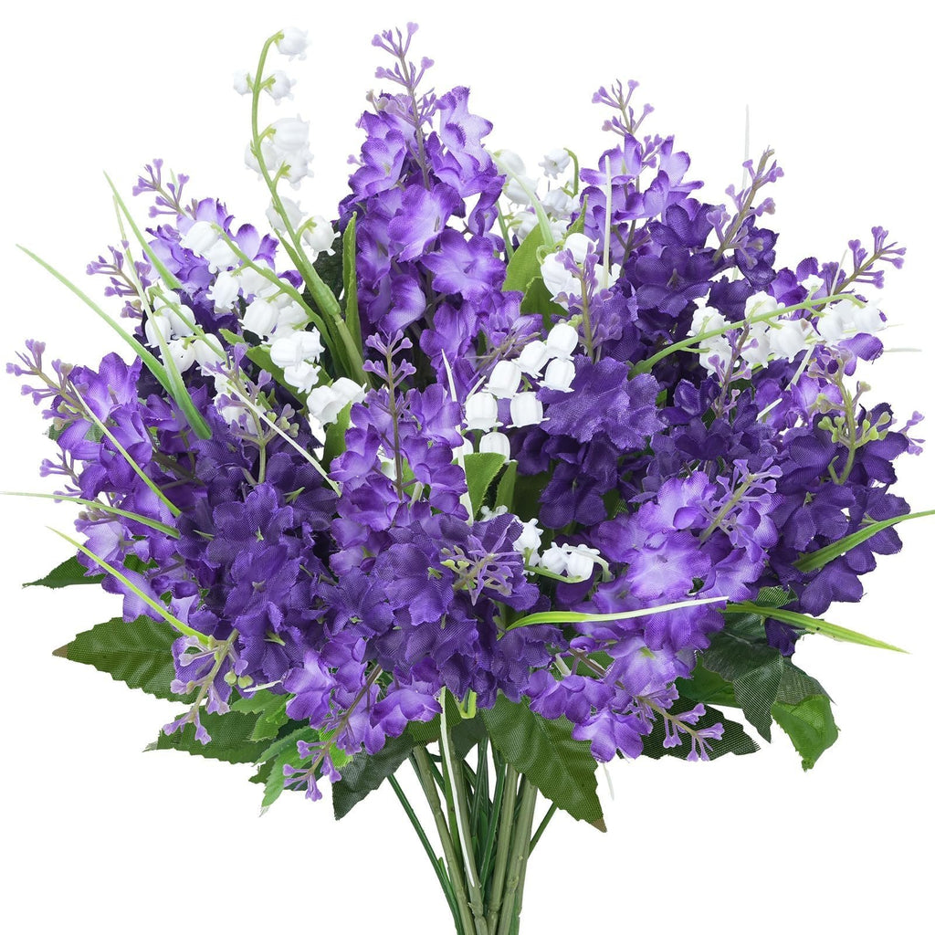Bouquet of purple artificial lilac and white campanula flowers with green leaves, presented against a white background.