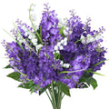 Bouquet of purple artificial lilac and white campanula flowers with green leaves, presented against a white background.