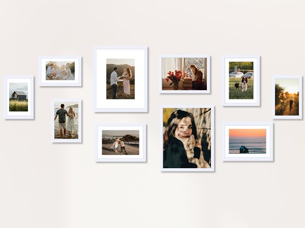 Collage of ten white picture frames displaying various family and scenic photos on a wall.
