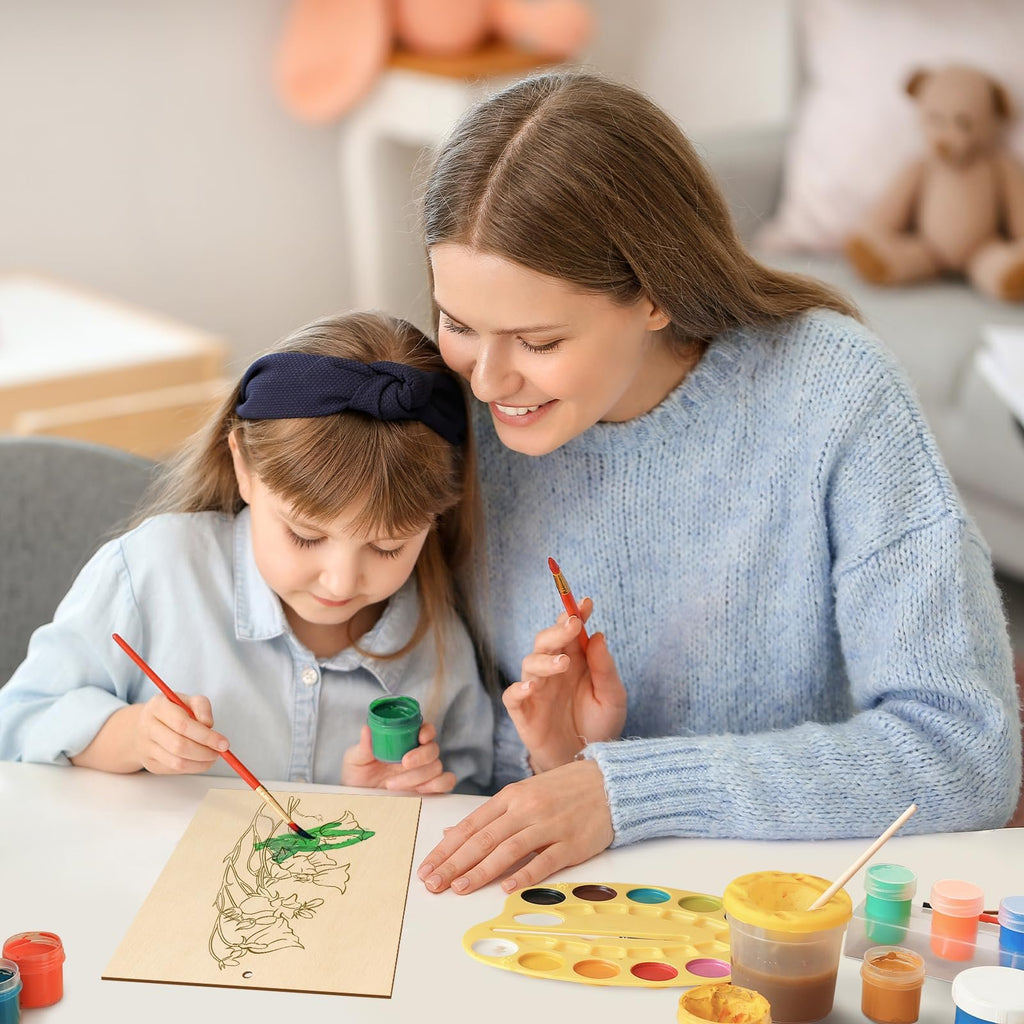 Mother and daughter painting a wooden flower ornament with watercolors at a table.