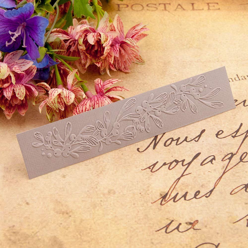Embossing folder with floral and leaf pattern, displayed with flowers on vintage paper.