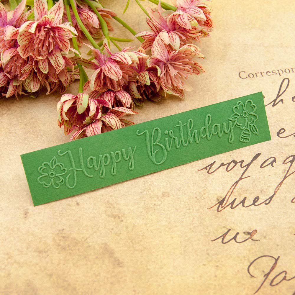 Green embossing folder with 'Happy Birthday' text and floral design, surrounded by pink flowers.