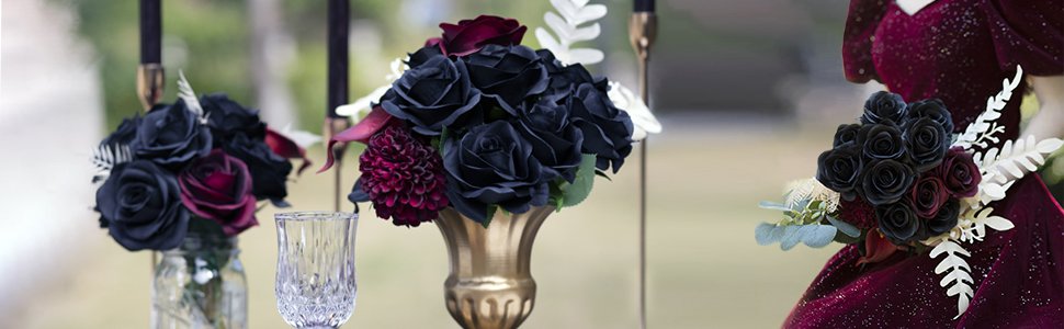 Burgundy and black silk rose bouquets arranged in vases and held by a person in a burgundy dress