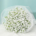 Bouquet of white artificial baby's breath flowers wrapped in white tulle and lace
