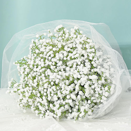 Bouquet of white artificial baby's breath flowers wrapped in white tulle and lace